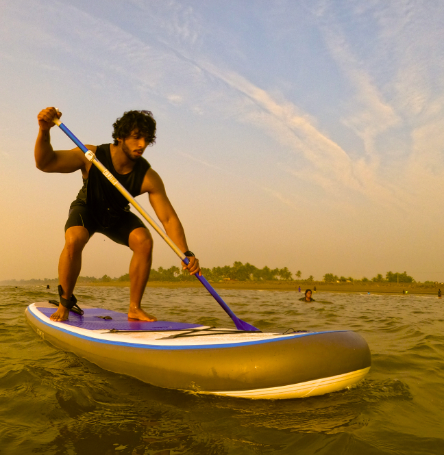 A guy paddling on Standup paddleboard in deep sea