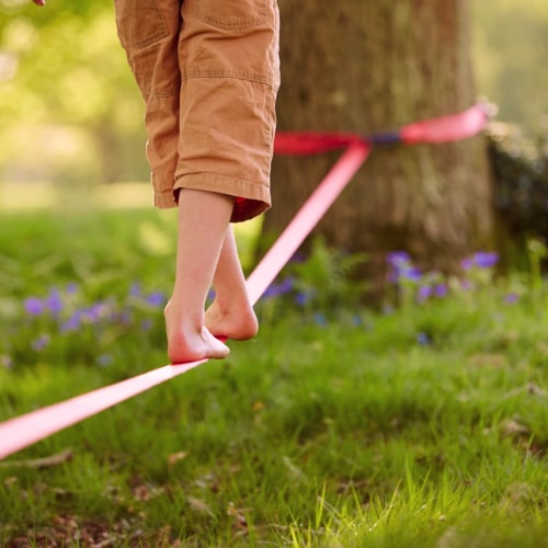 a cute little child doing slacklining in mumbai